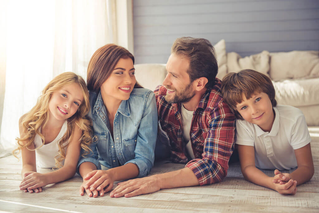 family laying on floor for photo